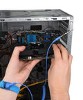 Hands installing graphics card in PC with blue anti-static wrist strap and grounding wire for Ground Yourself While Working On Sensitive Electronics With A 3 Pack Of Reusable Anti Static Wrist Straps With Grounding Wire And Alligator Clip For Maximum ESD Protection When Installing RAM Or Graphics Cards On Your PC Includes Two Black And One Blue.
