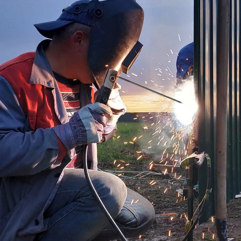 Welder using E6013 Welding Rod For Carbon Steel Three Thirty Second Inch Diameter Two Pound Electrodes with sparks flying