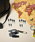 Grab This All In One Zipper Repair Kit 12 Piece Black Slider Replacement Set In 3 Sizes For Jackets Backpacks Luggage And Travel Gear Quick Fix Zipper Sliders Rescue shown with map and travel items