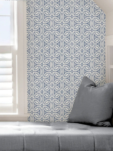 Hepatica Petal Peel And Stick String Wallpaper in blue floral pattern on a wall with window and grey sofa, no residue, easy to install.
