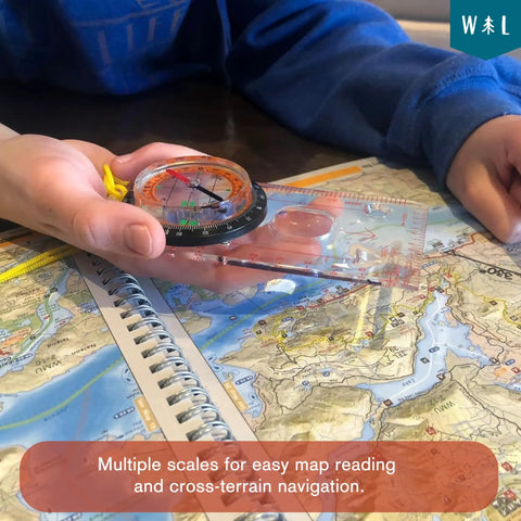 Person using Liquid Filled Compass Kit For Hiking With Trail Ready Rotating Bezel, Quick Tip Guide, And Carabiner over a map