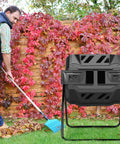 43 Gallon 163L Dual Chamber Compost Tumbler With Sliding Doors And Stable Metal Frame in garden setting with person raking leaves
