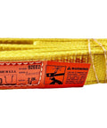 Side view of 2-in x 4-ft yellow nylon lifting sling with flat-eye ends and orange warning tag.