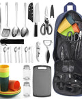 All In One Camping Kitchen Set With Stainless Steel Tongs Slotted Spatulas Spoons Chef Knife Kitchen Shears Bottle Opener Peeler And Spice Bottles Plus A Chopping Board And Four Plastic Plates For Outdoor Cooking On The Go Picnics And BBQ displayed with bag and utensils