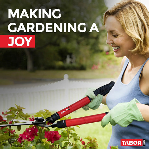 Woman using Telescopic Hedge Shears With Wavy Blade And Extendable Steel Handles For Easy Reach Trimming Of Tall Hedges Boxwood And Borders