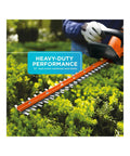 Close-up of 20V Max Cordless Hedge Trimmer With 22 Inch Dual-Action Steel Blade cutting through bushes, showcasing low vibration performance.