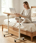 Rolling Laptop Standing Desk With Adjustable Tilting Tabletop And Smooth Locking Casters Lightweight Foldable Computer Workstation in bedroom.