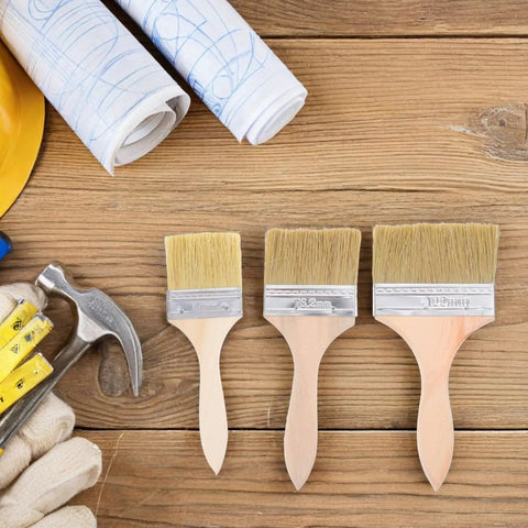 Wood Handle Paint Brush Set, 3 pack flat stain brushes for furniture and wood on a wooden surface, includes 2.5, 3, 4 inch sizes.