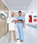 Heavy Duty AED Defibrillator Wall Cabinet in hospital corridor with two medical professionals reviewing information.