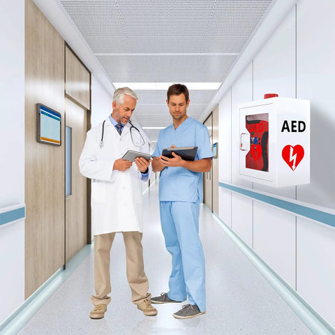 Heavy Duty AED Defibrillator Wall Cabinet in hospital corridor with two medical professionals reviewing information.
