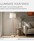 Ellis 21 Inch Table Lamp With Natural Rubber Wood And White Fabric Shade next to a couch in a living room setting.