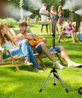 Adjustable Standing Misting System For Outdoor Patio, 4.1 Ft Height With Tripod Stand, cooling lawn with people relaxing.