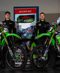 Two motocross bikes with riders in racing gear, standing beside a Yamaha YZ and WR Linkage Bearing Rebuild Kit banner.