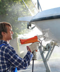 Person using Powerful Propane Heat Gun With 187660 BTU Output Adjustable Regulator on boat hull for shrink wrapping