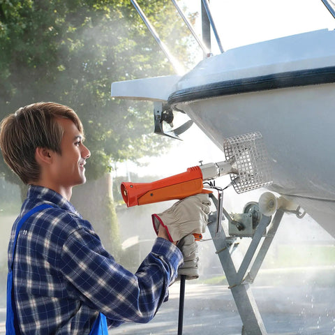 Person using Powerful Propane Heat Gun With 187660 BTU Output Adjustable Regulator on boat hull for shrink wrapping