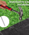 Using a hammer to install 200 Pack 6 Inch Landscape Staples, 11 Gauge Galvanized U Shaped Garden Stakes for lawn setup