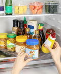 Person using Rectangular Lazy Susan Organizer For Large Refrigerator With 360 Degree Turntable 16.54 Inch Rotation Shelf with condiments