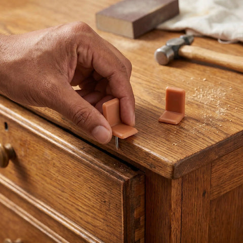 Hand installing Universal L Shape Drawer Glides Kit 50 Pieces Tack In Drawer Sliders For Furniture on wooden dresser