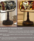 Stained Glass Butterfly Style Bankers Lamp With Handcrafted Design on wooden table and lit with LED bulb