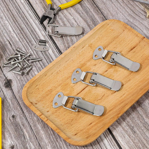 Stainless Steel Spring Loaded Toggle Latch Set Four Pack With Screws Heavy Duty Metal Locking Latch on wooden tray with screws