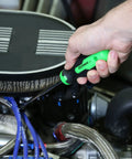 OEMTOOLS hose remover tool in green and black held in hand near radiator hoses in an engine bay