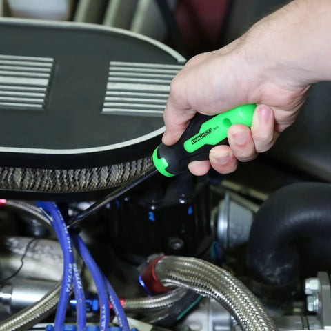 OEMTOOLS hose remover tool in green and black held in hand near radiator hoses in an engine bay