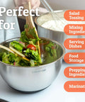 Person preparing salad with Stainless Steel Mixing Bowls With Lids Set Featuring Airtight Lids And Non Slip Base, Five Nesting Bowls