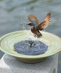 Bird landing on Solar Fountain Bird Bath Bubbler For Outdoor Garden Made Of Metal Water Feature For Patio Decor Sun Powered No Battery Needed Easy Setup Creates Sparkling Water Sprays That Attract Birds