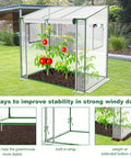 Portable Mini Greenhouse For Indoor And Outdoor Use With Thick PE Cover And Clear Panels in a garden with tomato plants