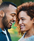 Couple smiling while wearing Snag These Fresh Flat Back Earrings Made From Light As Air Titanium Surgical Steel With Diamond Like Cubic Zirconia.