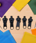 Six Black Zipper Sliders Replacement Kit For Quick Fixes On Jackets Backpacks And Clothes Instant Zip Repair Pack displayed on table