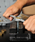 Demonstrating Titanium-Coated SAE Tap And Die Set With Storage Case in use on a bolt with a vise, 40-piece UNC and UNF kit for repairs.