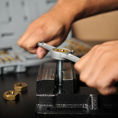 Demonstrating Titanium-Coated SAE Tap And Die Set With Storage Case in use on a bolt with a vise, 40-piece UNC and UNF kit for repairs.