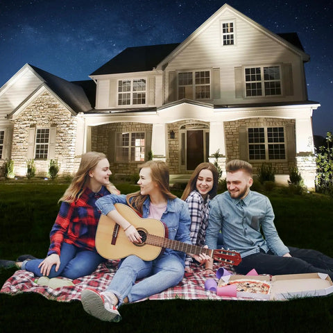 Family enjoying picnic on lawn with outdoor wall washer light bar pair 36W 5000K daylight white LED linear lighting