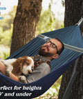 Man relaxing with dog in Adjustable Hammock With Sturdy Collapsible Stand For Camping And Outdoor Use 550 Lb Capacity Double Hammock