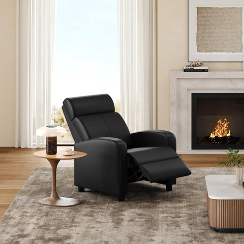 Comfy PU Leather Recliner Chair For Home Theater Seating With Lumbar Support in a living room, reclined near fireplace.