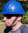 Man wearing blue All Day Comfort Full Brim Construction Hard Hat OSHA Approved Vented Safety Helmet with 6 Point Ratchet Chin Strap.