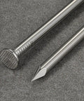Close-up of 4 Inch 304 Stainless Steel Nails Pack Of 19 showing head and point detail on a grey surface.
