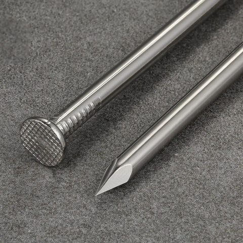Close-up of 4 Inch 304 Stainless Steel Nails Pack Of 19 showing head and point detail on a grey surface.