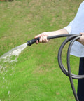 Heavy Duty 50 Foot Braided Garden Hose With Lightweight Flexible Design Kink Resistant And Tangle Free Leak Free Connections Swivel Handle Male To Female Fittings Triple Layer Hybrid Material Durable Grey in use on lawn
