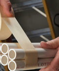 Beige General Purpose Masking Tape 203, 48 Mm By 55 M Crepe Tape for bundling pipes, demonstrating pressure-sensitive adhesion
