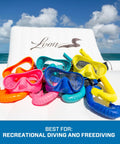 Colorful snorkel sets with masks and J-tube design displayed on a chair, highlighting Apnea Freedive Snorkel With Foldable J Tube Design.