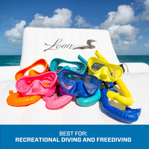 Colorful snorkel sets with masks and J-tube design displayed on a chair, highlighting Apnea Freedive Snorkel With Foldable J Tube Design.