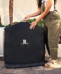 Person holding Universal Stroller Travel Bag For Air Travel, Durable, Padded Go To Case near luggage, outdoor setting