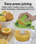 Hamilton Beach 34 Oz Electric Citrus Juicer With Silicone Gripper Lid Easy Press Juice Extraction in use with fresh orange