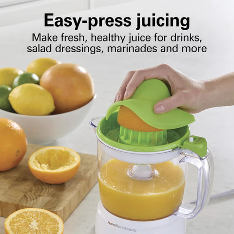 Hamilton Beach 34 Oz Electric Citrus Juicer With Silicone Gripper Lid Easy Press Juice Extraction in use with fresh orange