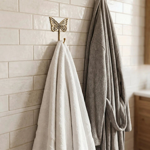Solid Brass Butterfly Wall Hooks With 33 Lb Capacity, Vintage Gold Finish holding towels, bathroom setting