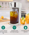 Generous 3 Quart White Stainless Steel Iced Tea And Cold Brew Coffee Brewing Pitcher With Adjustable Strength Dial and Removable Infuser Chamber on kitchen counter.
