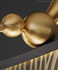 Detail of Sleek Modern Linear Pendant Light That Hits Different On Your Kitchen Island Or Dining Table with stylish gold accents.