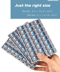 Hand holding labeled compartments of Comprehensive EIA 0805 SMD Chip Resistor Kit For Pros With 72 Values From 0 Ohm To 10 Meg Ohm 7200 Pieces 1 Percent Tolerance RoHS Compliant Great For Prototyping Repair And Electronics Projects